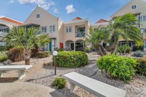 a house with a bench in front of it at Port Bonaire Seascape A301 with Sea Views and Pool in Kralendijk