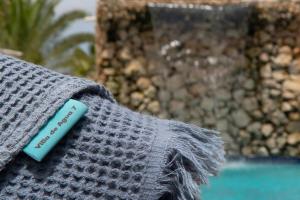 ein grauer Pullover mit einem blauen Etikett in der Unterkunft Villa de Agua 7 in Waterlands Village in Kralendijk