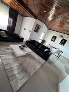 a living room with a couch and a table at private Home in Douala