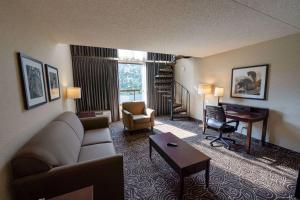 a living room with a couch and a table and a desk at Hotel 116, A Coast Hotel Bellevue in Bellevue