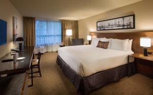 a hotel room with a large bed and a desk at Hotel 116, A Coast Hotel Bellevue in Bellevue
