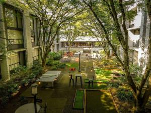 a park with tables and benches in a courtyard at Hotel 116, A Coast Hotel Bellevue in Bellevue