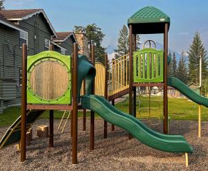 a playground with two slides and a gazebo at Tekarra Lodge in Jasper