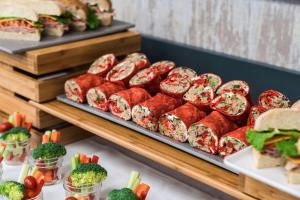 a buffet of food with sandwiches and vegetables at Coast Langley City Hotel & Convention Centre in Langley