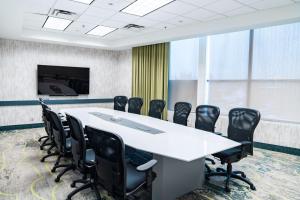 a conference room with a white table and black chairs at Coast Langley City Hotel & Convention Centre in Langley