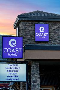 a building with two signs on top of it at Coast Osoyoos Beach Hotel in Osoyoos