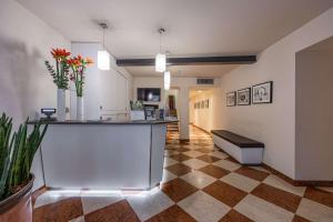 a lobby with a counter and flowers in a room at Best Western Hotel Armando in Verona