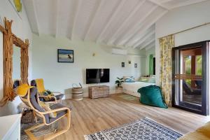 een woonkamer met een bank en een tv bij Lac Bay Casita 5 in Kralendijk