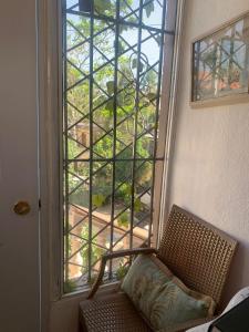 a chair in front of a window with a view at Descansa y viaja bleseed house in Monte Adentro