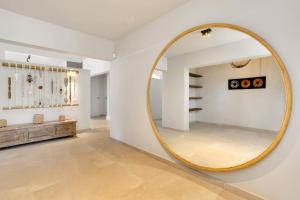 a large round mirror on a wall in a room at Tres Ojos in Sabadeco in Kralendijk +17 photos