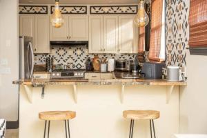 a kitchen with a counter and two stools at Boho Lux in Atlanta