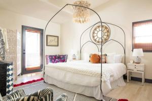 a bedroom with a large white bed and a chandelier at Boho Lux in Atlanta