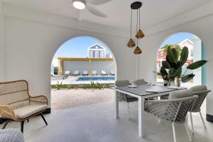 a dining room with a table and chairs and a pool at Kas Ereda Ground floor Apartment with Pool in Kralendijk