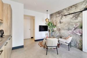 a dining room with a wall mural of pink flamingos at Kas Ereda Ground floor Apartment with Pool in Kralendijk