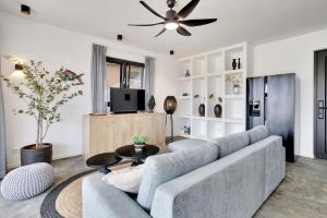 a living room with a couch and a tv at Villa Valena Apartment 1 with Cooling Pool in Kralendijk