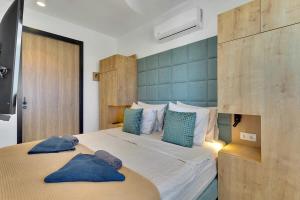 a bedroom with a bed with two blue pillows on it at Villa Valena Apartment 6 with Cooling Pool in Kralendijk +24 photos
