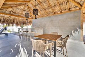 a dining room with a wooden table and chairs at Villa Valena Apartment 6 with Cooling Pool in Kralendijk