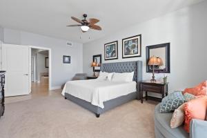 a bedroom with a bed and a couch at Turquoise Place By Liquid Life in Orange Beach