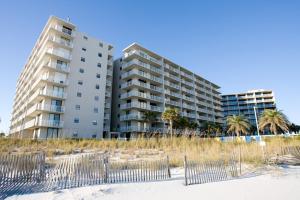 two tall buildings on the beach with palm trees at Seaside Beach Racquet 3504 in Orange Beach