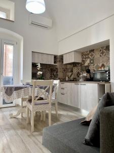 a kitchen with a table and chairs in a room at Casa Cecilia - Puglia Mia Apartments in Monopoli