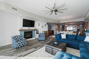 a living room with blue furniture and a fireplace at Turquoise Place 2307-C Luxury Gulf Front Condo in Orange Beach