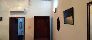 a hallway with a door and two pictures on the wall at Ananda Villa Kosgoda Since 1995 in Kosgoda