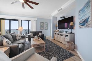 a living room with a couch and a table at Phoenix I 1153 in Orange Beach