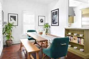 a dining room with a table and green chairs at Boutique La TiQue in Atlanta