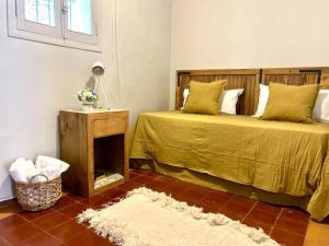 a bedroom with two beds and a rug at Cálida casa en el corazón de Chacras de Coria in Ciudad Lujan de Cuyo