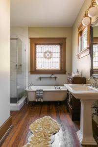 a bathroom with a tub and a shower and a sink at Pecan Park in Atlanta