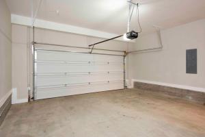 an empty garage with white walls and white garage doors at Sky's the Limit in Atlanta +31 photos