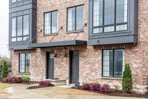a red brick building with black windows at Sky's the Limit in Atlanta