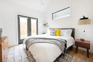 a white bedroom with a bed and a window at Dapper Dan in Atlanta