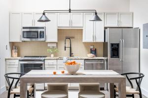 a kitchen with a table with a bowl of oranges on it at Beltline Shrine in Atlanta