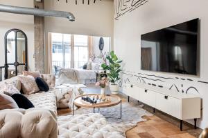a living room with a couch and a tv at Beltline Shrine in Atlanta