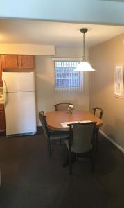 a kitchen with a table with chairs and a refrigerator at Condo with Pool and Hot Tub at Lake Ozarks in Osage Beach