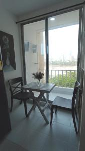 a table and chair in a room with a balcony at SUITES IN CARTAGENA QUiET LOCATION NEXT TO THE BEACH in Cartagena de Indias