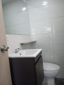 a bathroom with a sink and a toilet and a mirror at SUITES IN CARTAGENA QUiET LOCATION NEXT TO THE BEACH in Cartagena de Indias