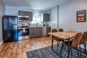 a kitchen with a wooden table and a wooden floor at Mountain Retreat for Adventures - 2nd Floor in Whitefield