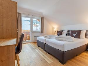 a bedroom with a large bed and a large window at Chalet Bergblick in Sankt Margarethen im Lungau