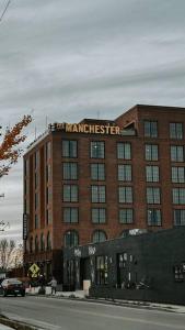 a large red brick building with a manchester sign on it at Winner's Circle in The City in Lexington