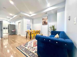 a living room with a blue couch and a table at Regal 5B Retreat on King St Old Town Alexandria in Alexandria