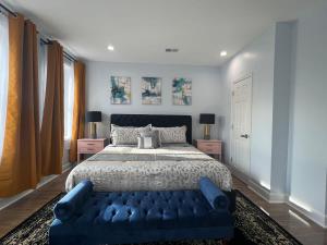 a bedroom with a large bed and a blue couch at Majestic 4B Retreat on King St-5 Mins Walk Metro in Alexandria