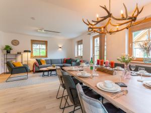 a dining room and living room with a large table and chairs at Haus Rapunzel in Donnersbachwald