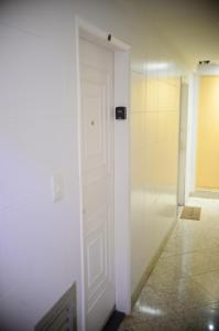 a white door in a room with a hallway at Vista Mar Luxo Copacabana in Rio de Janeiro