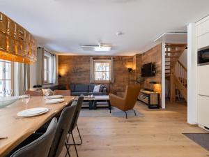 a kitchen and living room with a table and chairs at Steier Hütte S in Donnersbachwald