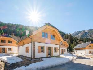 a home in the mountains with the sun behind it at Steier Hütte S in Donnersbachwald