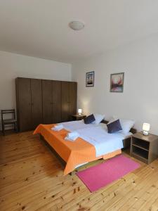 a bedroom with a large bed and a wooden floor at Apartments with a parking space Slano, Dubrovnik - 8540 in Slano