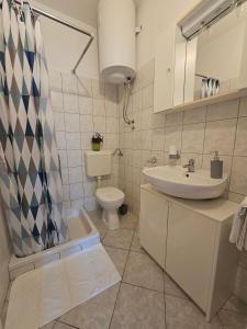 a bathroom with a sink and a toilet at Apartments with a parking space Slano, Dubrovnik - 8540 in Slano