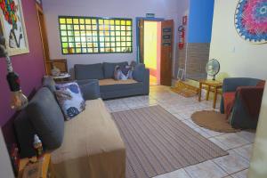 a living room with a blue couch and a table at Pousada Linda Flor in Alto Paraíso de Goiás